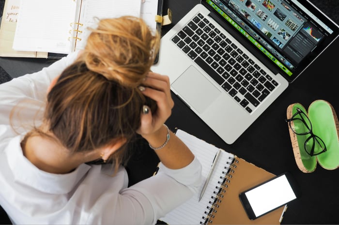 frustrated-woman-holding-head-computer