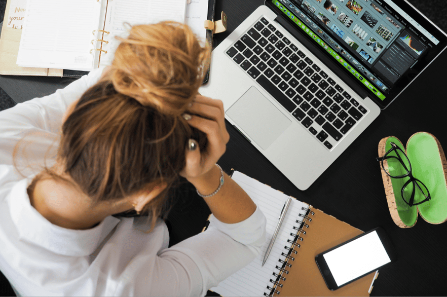frustrated-woman-holding-head-computer