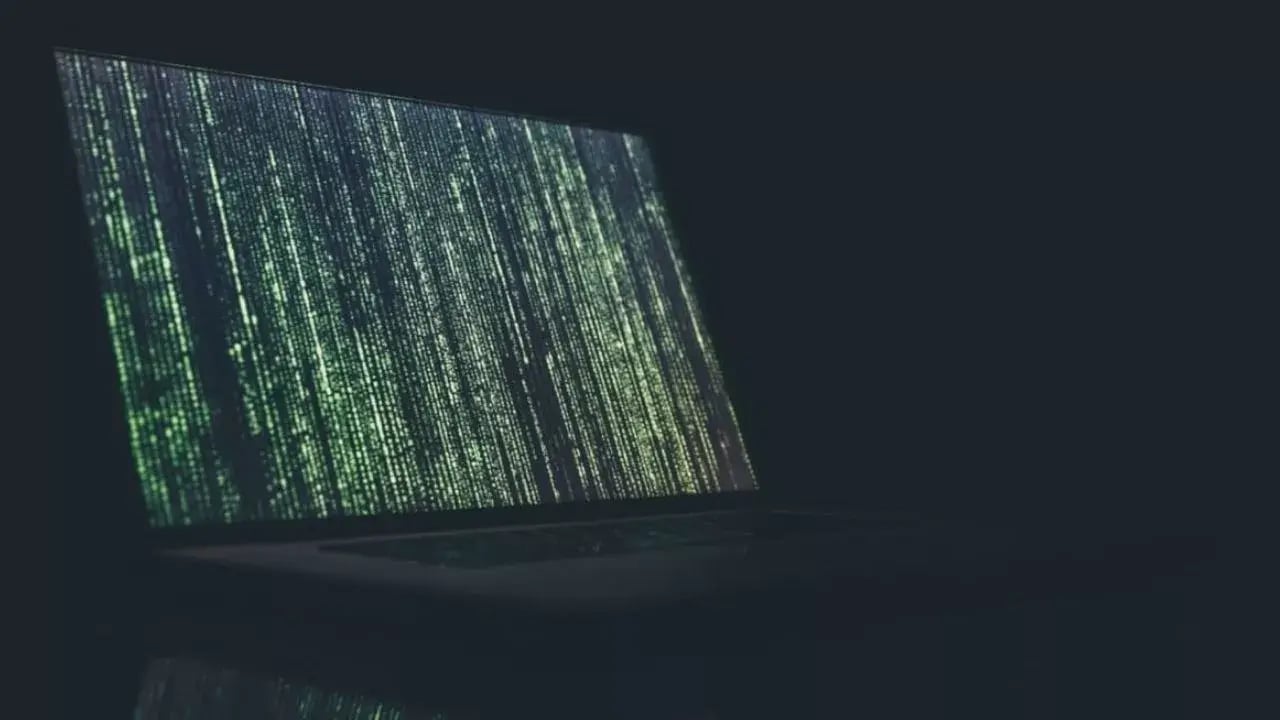 A computer in the dark with pixels