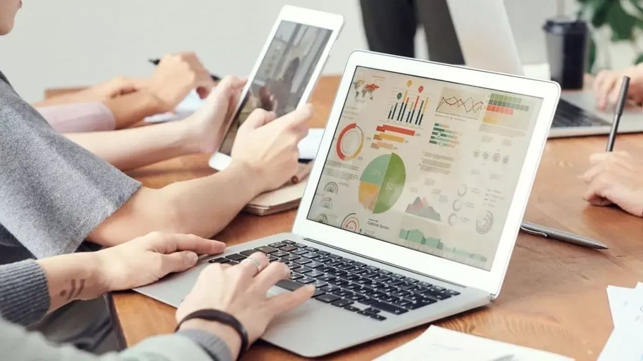 Individuals working on laptops