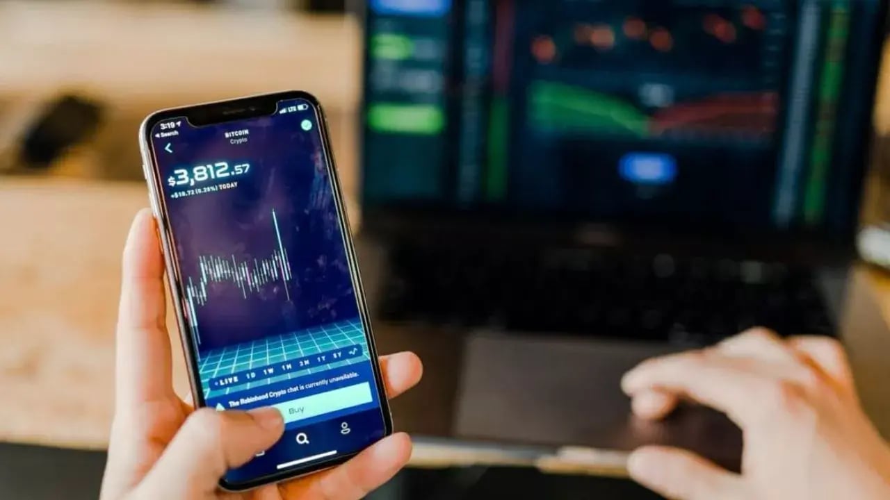 Holding a mobile phone and working on the computer at the same time