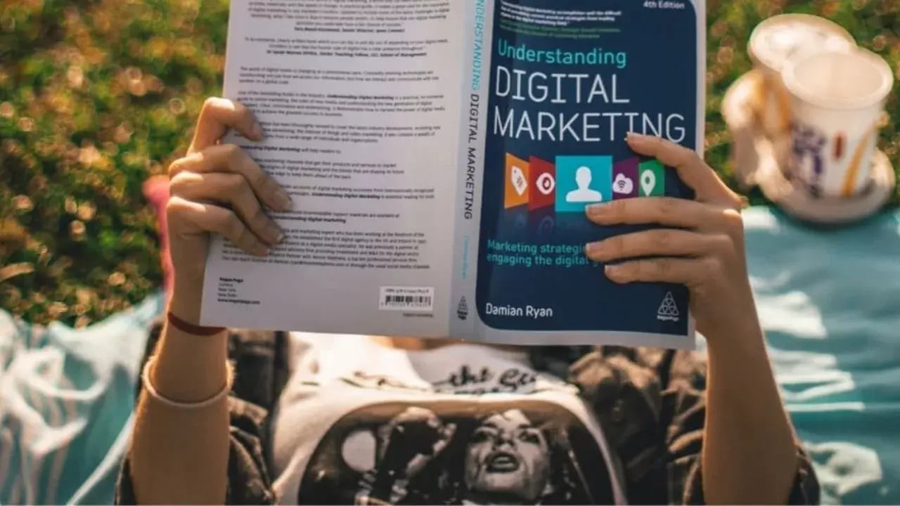 A girl reads a digital marketing book