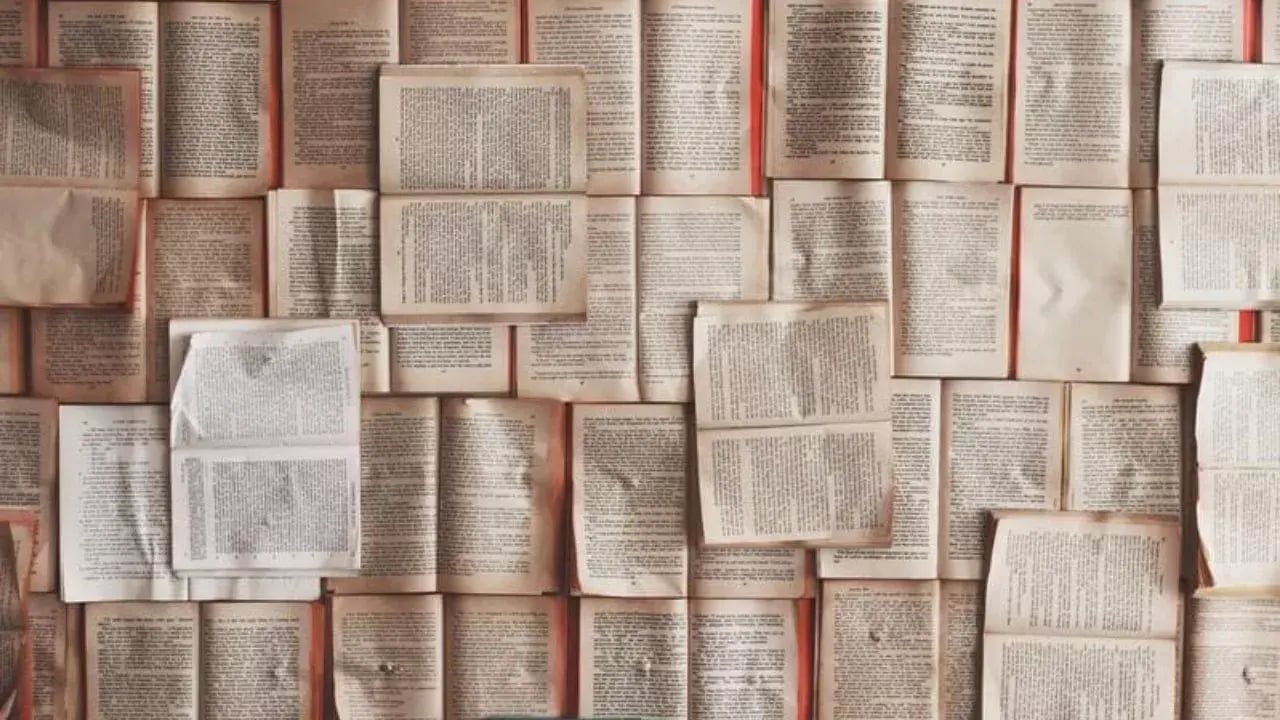 A wall covered with pages from books