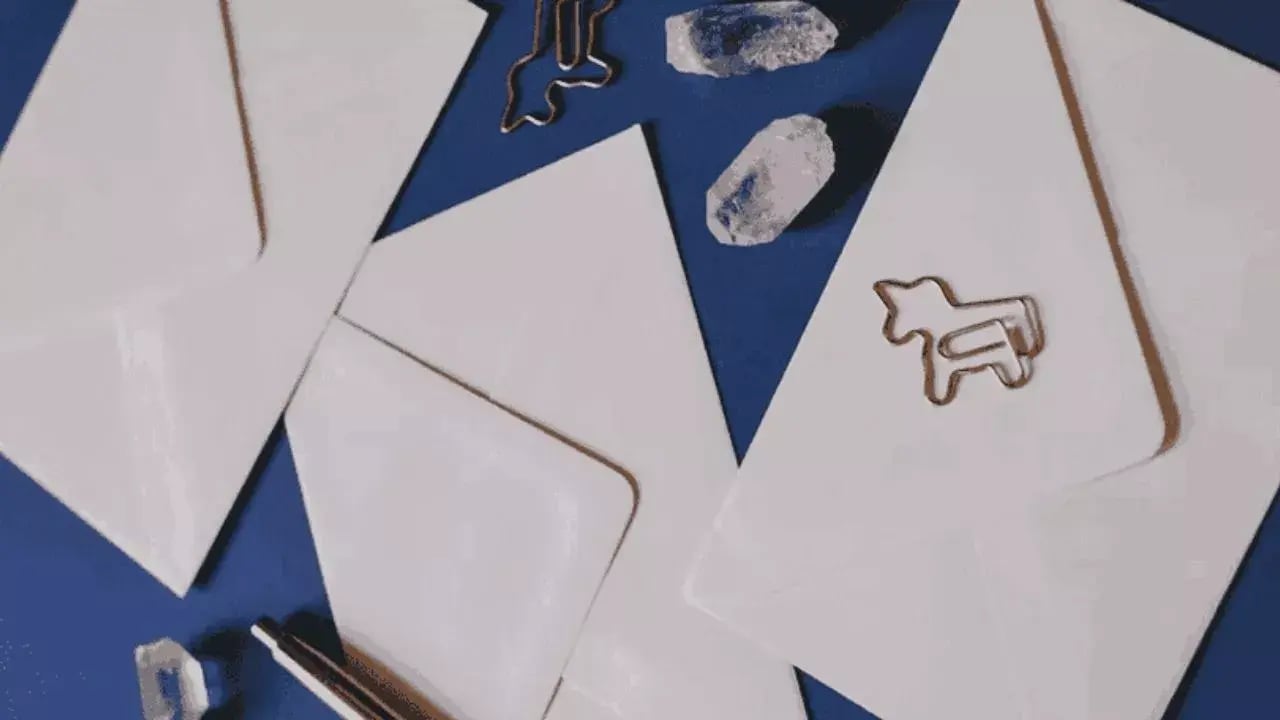 Several white envelopes arranged on a blue background,