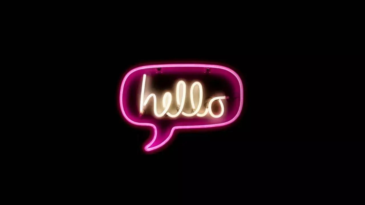 a neon sign shaped like a speech bubble, with the word 