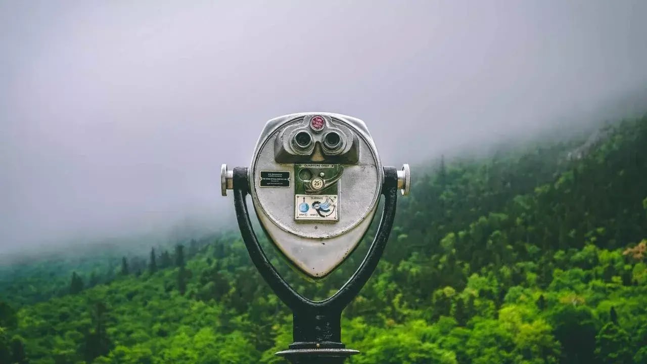 a vintage coin-operated binocular viewer with magnifying lenses