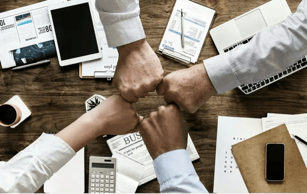 teamwork is celebrated with a fist bump